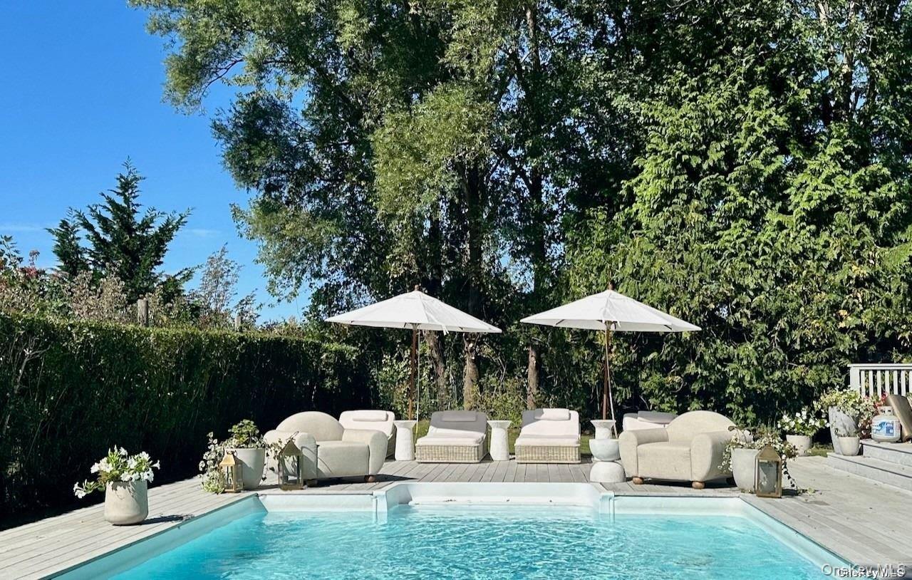 62 Sea Farm Lane Bridgehampton, NY 11932 - Photo 8 of 25 a view of backyard with seating space and trees