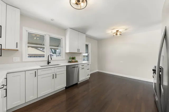 a kitchen with sink cabinets and wooden floor