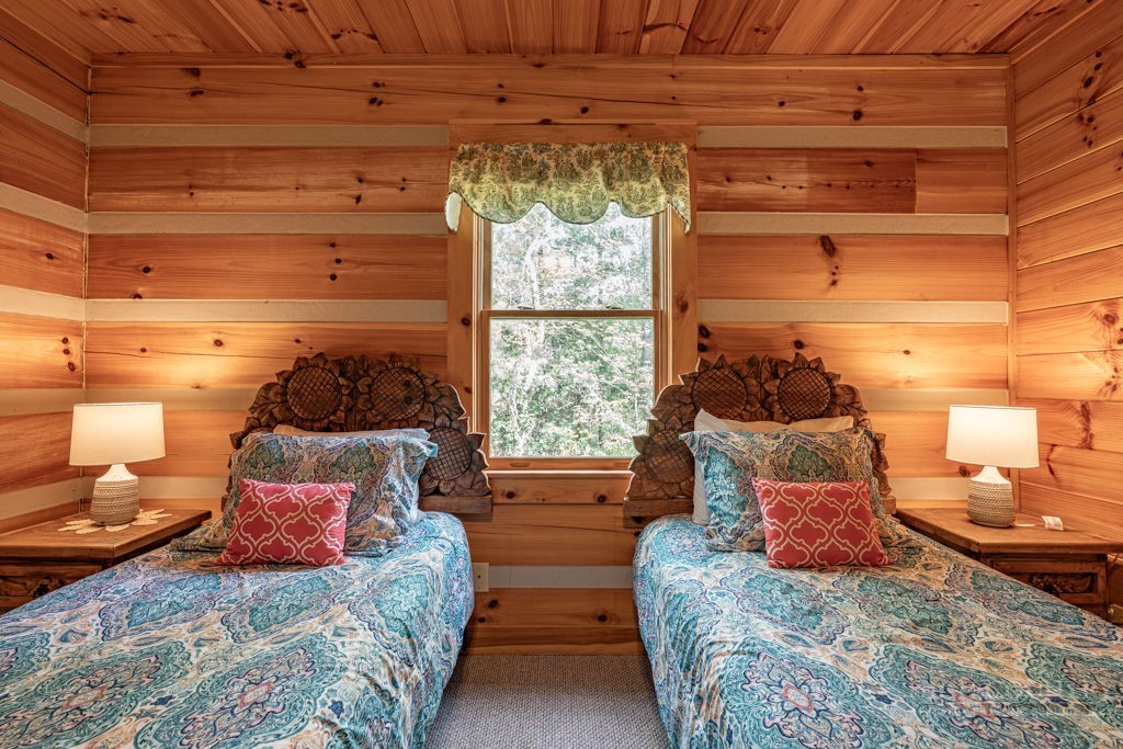 197 Woodby Ridge Road Vilas, NC 28692 - Photo 19 of 45 a bedroom with two beds and a window