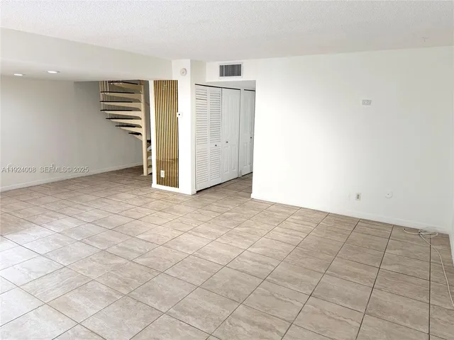 a bathroom with a granite countertop sink and a toilet