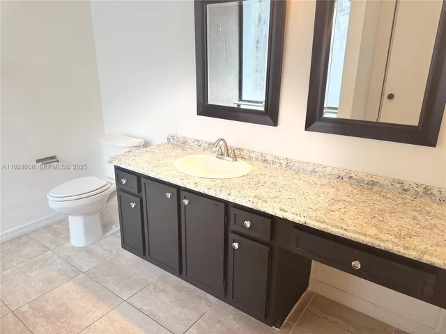 a bathroom with a sink a toilet and a shower