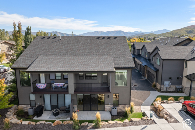 1141 520 West Midway, UT 84049 - Photo 33 of 40 Contemporary exterior with a dark grey shingle roof, stucco siding, and stone accents