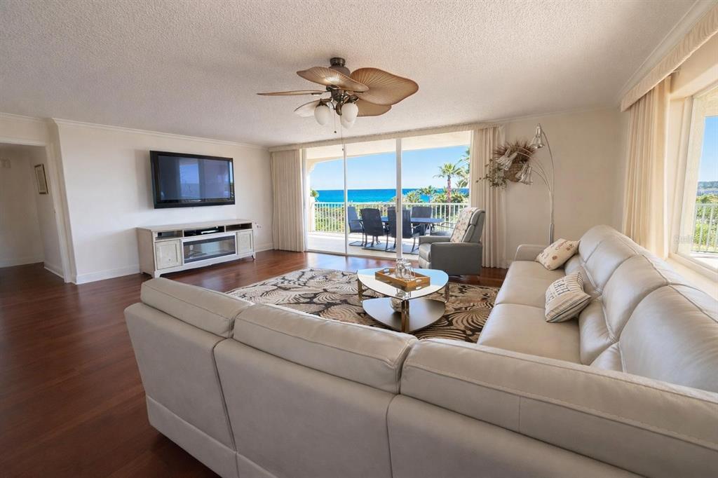 420 Harding Avenue, Unit 301 Cocoa Beach, FL 32931 - Photo 1 of 57 a living room with furniture and a flat screen tv