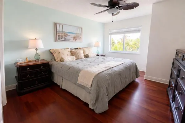 a bedroom with bed dresser and a window