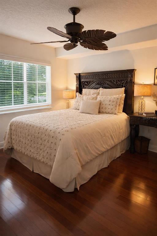 420 Harding Avenue, Unit 301 Cocoa Beach, FL 32931 - Photo 21 of 57 a bedroom with a bed and wooden floor