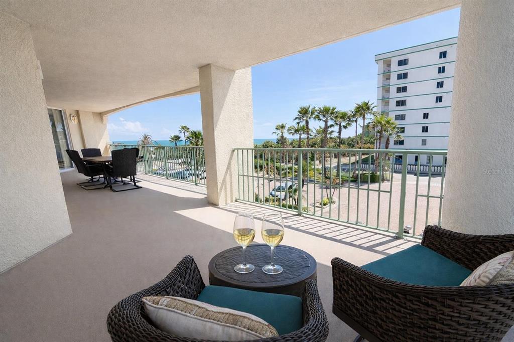 420 Harding Avenue, Unit 301 Cocoa Beach, FL 32931 - Photo 26 of 57 a living room with furniture and a floor to ceiling window
