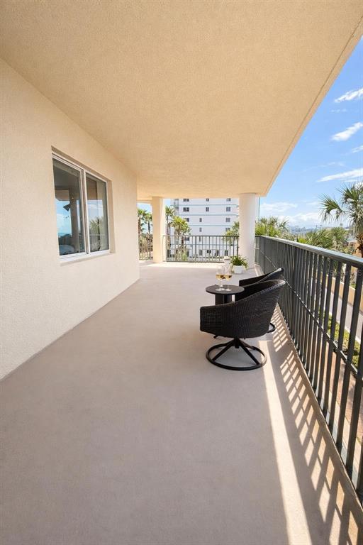 420 Harding Avenue, Unit 301 Cocoa Beach, FL 32931 - Photo 27 of 57 a living room with furniture and a floor to ceiling window