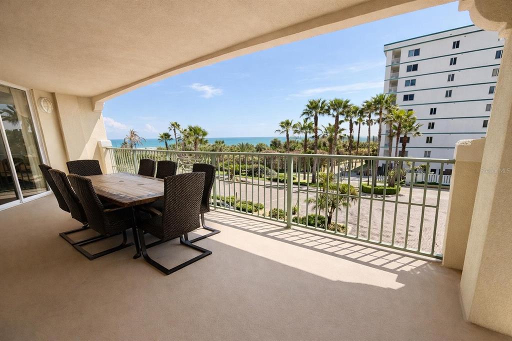 420 Harding Avenue, Unit 301 Cocoa Beach, FL 32931 - Photo 29 of 57 a view of a chairs and table in patio