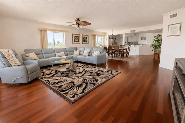 a living room with furniture and wooden floor
