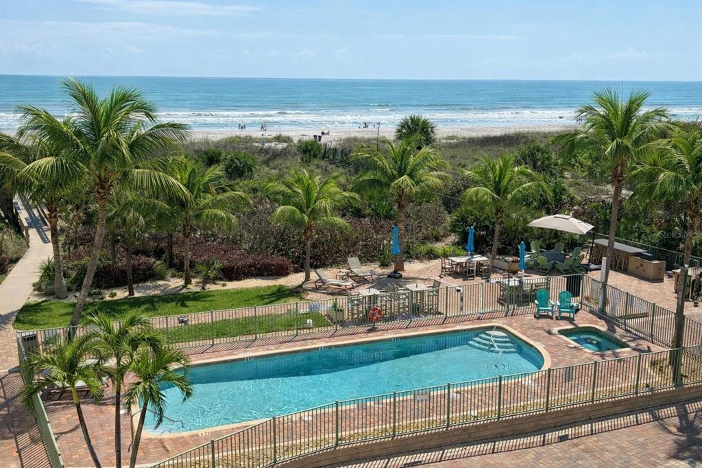 420 Harding Avenue, Unit 301 Cocoa Beach, FL 32931 - Photo 31 of 57 a view of a swimming pool and lounge chairs