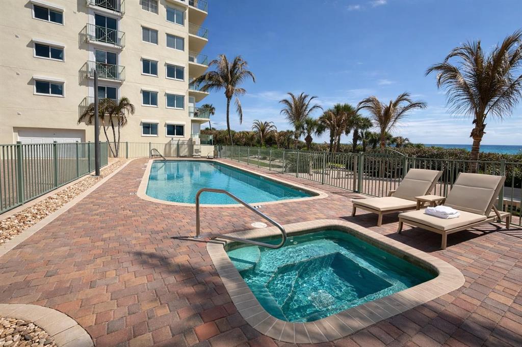 420 Harding Avenue, Unit 301 Cocoa Beach, FL 32931 - Photo 32 of 57 a swimming pool with outdoor seating and yard