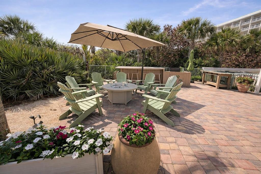 420 Harding Avenue, Unit 301 Cocoa Beach, FL 32931 - Photo 34 of 57 a view of a chairs and tables in the patio