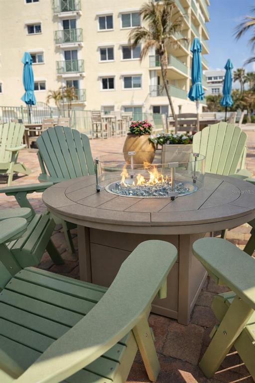 420 Harding Avenue, Unit 301 Cocoa Beach, FL 32931 - Photo 35 of 57 a balcony with table and chairs