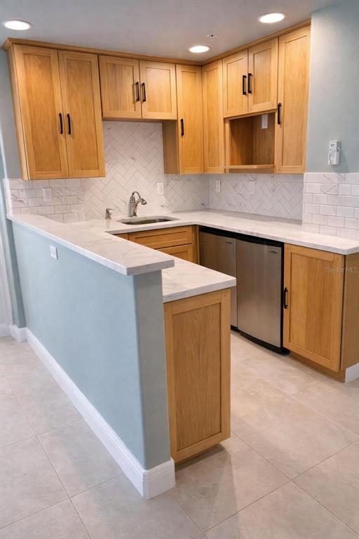 420 Harding Avenue, Unit 301 Cocoa Beach, FL 32931 - Photo 41 of 57 a kitchen with stainless steel appliances a stove a microwave a sink and a microwave