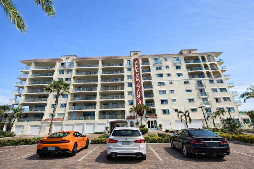 420 Harding Avenue, Unit 301 Cocoa Beach, FL 32931 - Photo 43 of 57 a car parked in front of a building