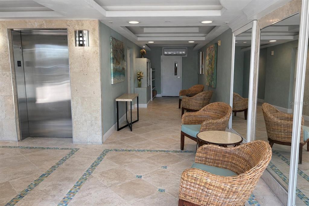 420 Harding Avenue, Unit 301 Cocoa Beach, FL 32931 - Photo 45 of 57 a living room with furniture and a glass door shower