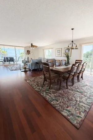 a living room with furniture a dining table and a fireplace