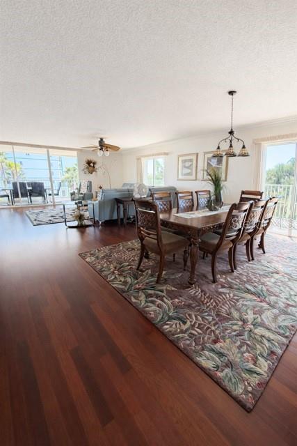 420 Harding Avenue, Unit 301 Cocoa Beach, FL 32931 - Photo 5 of 57 a living room with furniture a dining table and a fireplace