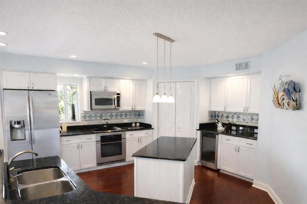 420 Harding Avenue, Unit 301 Cocoa Beach, FL 32931 - Photo 6 of 57 a kitchen with stainless steel appliances a refrigerator stove and sink