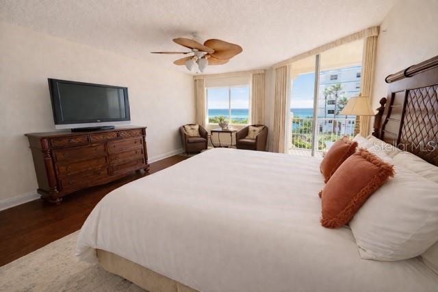 420 Harding Avenue, Unit 301 Cocoa Beach, FL 32931 - Photo 8 of 57 a bedroom with a bed and a flat screen tv