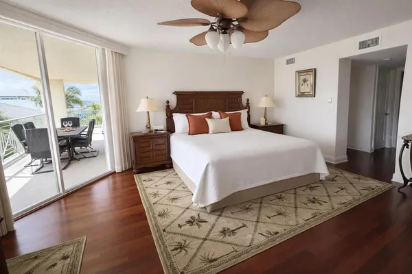 a bedroom with a large bed and a chandelier