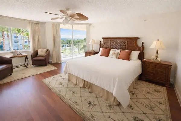 a large bed sitting in a bedroom next to a window