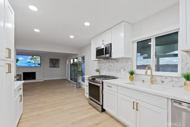 a kitchen with stainless steel appliances a stove microwave and cabinets