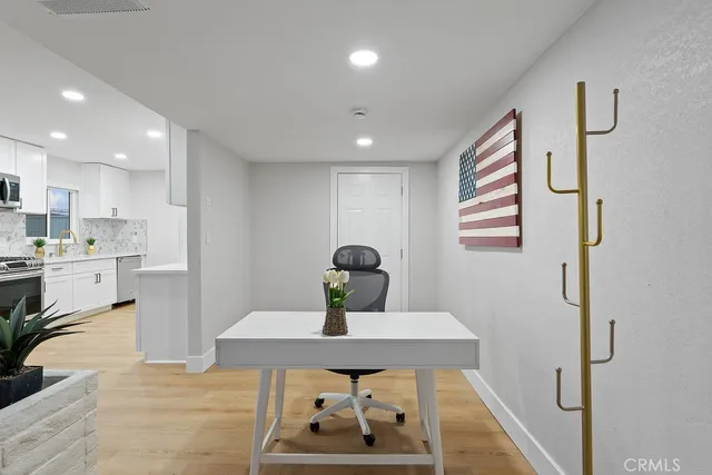a view of a room with wooden floor and white walls