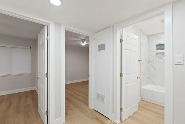 a view of an empty room with wooden floor