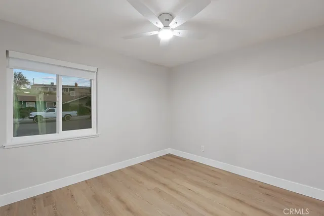 a view of a room with wooden floor