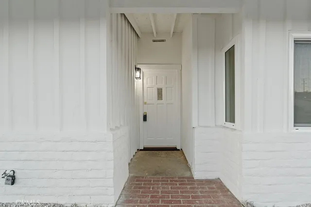 a view of a hallway with wooden floor and closet