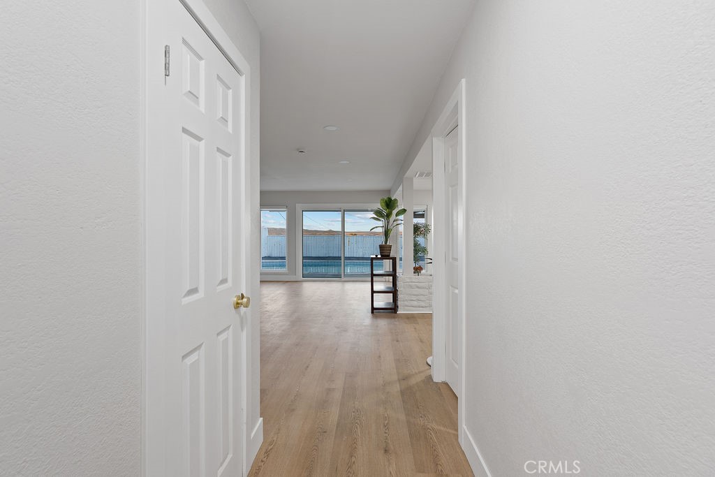 911 Keith Street Barstow, CA 92311 - Photo 5 of 40 a view of a hallway with wooden floor and closet