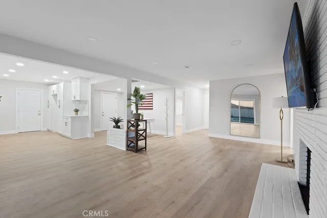 a view of a room with wooden floor and furniture