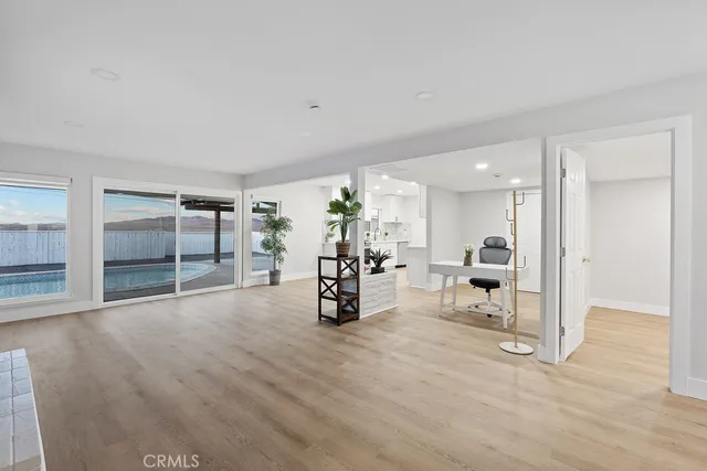 a large kitchen with stainless steel appliances granite countertop a stove a sink and a microwave