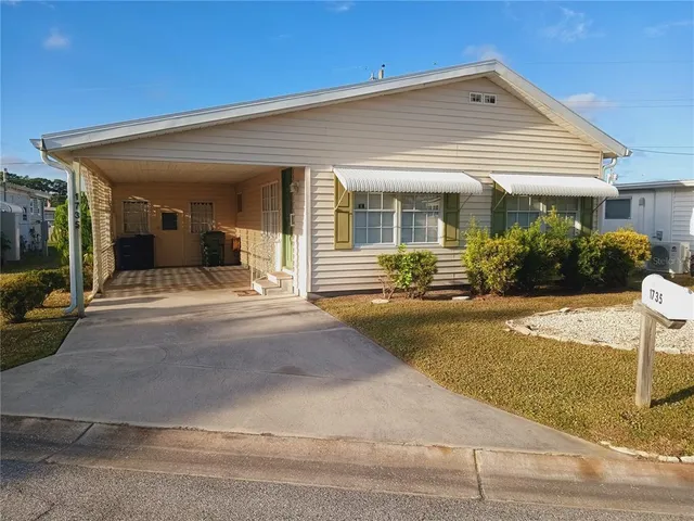 a view of a house with potted plants