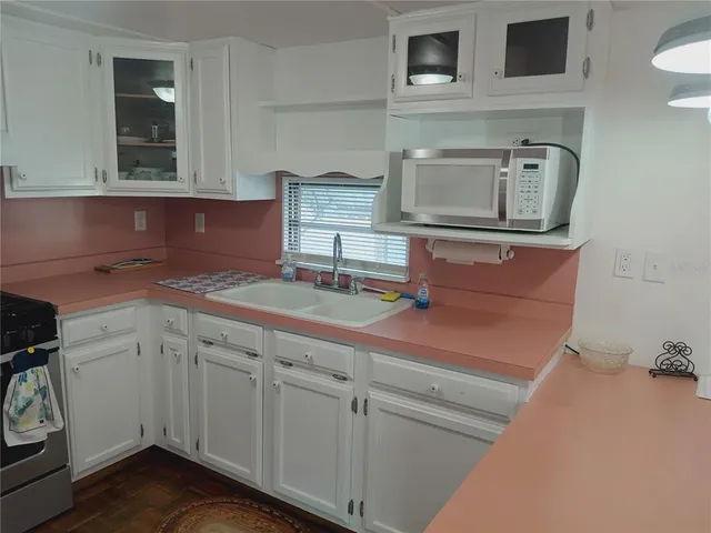 a living room with furniture and a lamp