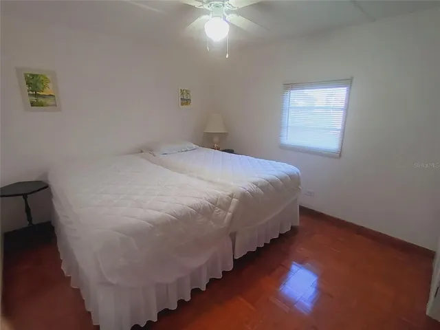 a large bed sitting in a bedroom next to a window