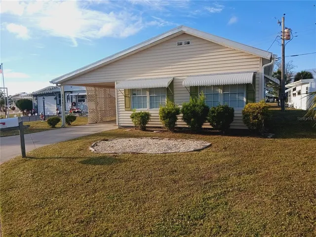a view of a house with backyard and garage