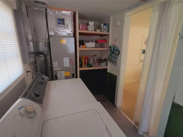 a kitchen with a sink a refrigerator and cabinets
