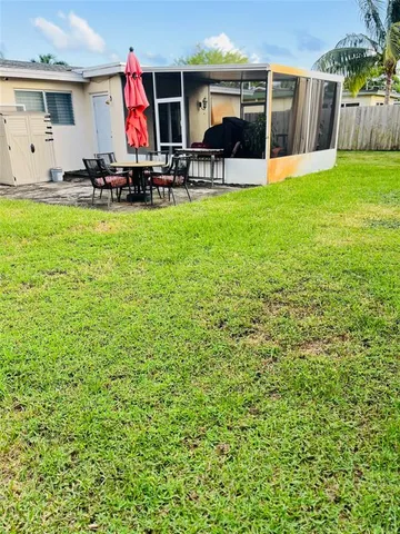 a view of a house with backyard porch and sitting area