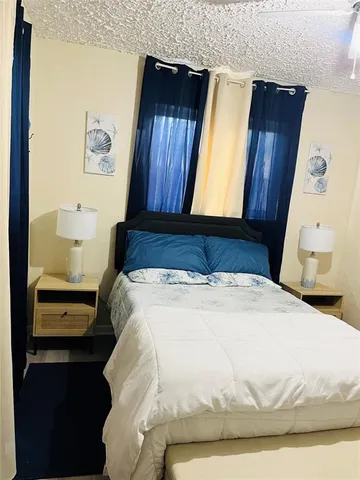 a bed sitting in a bedroom next to a window