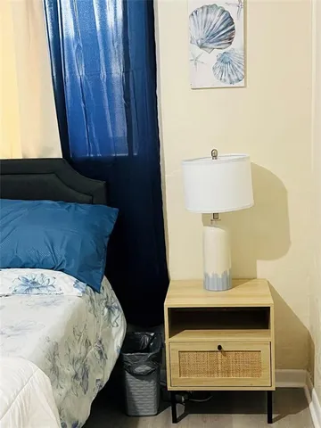 a bedroom with a bed and teddy bear on the dresser