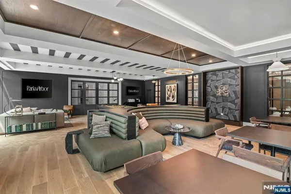 a room with furniture pool table table tennis table soccer and windows