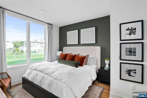 a living room with a bed and a window