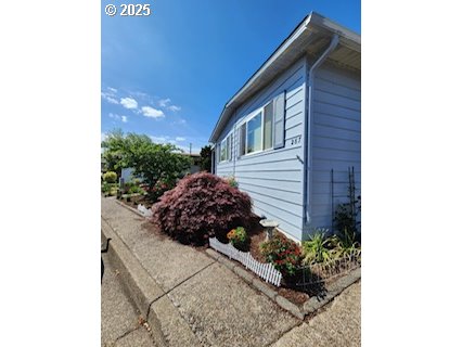 1199 North Terry Street, Unit 287 Eugene, OR 97402 - Photo 7 of 17 a view of a house with a small yard and plants
