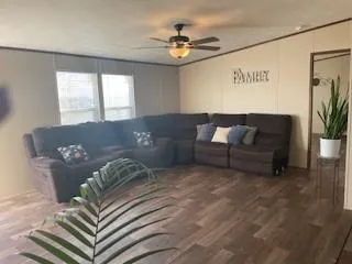 a living room with furniture and a large window