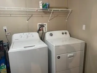 an empty room with closet and windows