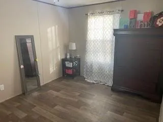 a bathroom with a granite countertop toilet and a sink