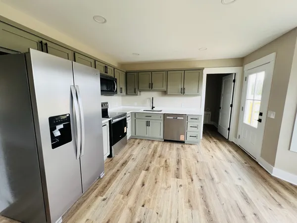a kitchen with stainless steel appliances a refrigerator and a stove