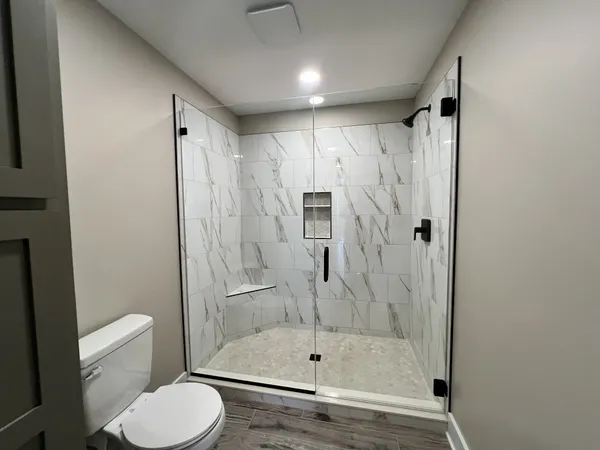 a bathroom with a shower and a toilet